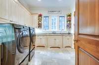 Spacious laundry room with an abundance of cabinetry