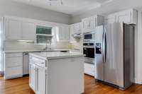 kitchen has new refrigerator, electric cooktop, new built in single oven. Also has microwave, dishwasher and disposal.