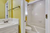 Commode and tub/shower area is accessed off vanity area via sliding door