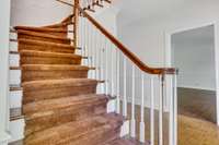 Gracious front staircase is in the front entry hall