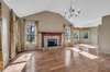 THE SPACIOUS LIVING ROOM WITH BEAUTIFUL HARDWOOD FLOORING AND VAULTED CEILING.