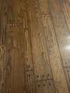 A CLOSE-UP OF THE BEAUTIFUL HARDWOOD FLOORING.