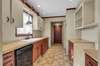 THE KITCHEN FEATURES LOTS OF CABINETS AND COUNTER SPACE.