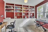 The office features built-in shelving with plenty of storage.