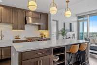 Three art deco pendant lights in luxe gold bring design and light to the kitchen.  Built-in shelving, additional cabinetry, and incredible natural light create a warm and inviting space.