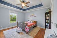 Back Secondary Bedroom with sophisticated trey ceiling and sand and finish hardwood flooring. A room that is bright and cheerful with space for not only sleeping but playing or studying.