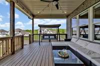 Covered porch perfectly situated to enjoy the evenings as the sun sets.