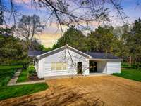 THIS IS A MUST SEE!!! SIDE VIEW OF THE HOME THAT SHOWCASES THE ONE CAR CARPORT AND ATTACHED STORAGE BUILDING.