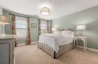 Cheery and bright, this upstairs bedroom has 2 large windows and a double-door closet.