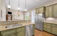 The Kitchen leads outside through glass french doors and has tons of counter and cabinet space. A designated pantry and an additional storage closet provide plenty of space for storing extra cooking equipment and serving dishes.