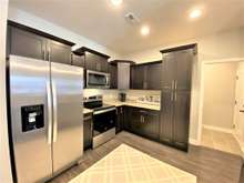 Large kitchen with stainless steel appliances, granite and custom cabinets (photo is of model home with same floor plan)