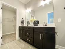 Master bathroom with two sinks, walk-in closet and shower (photo is of model home with same floor plan)