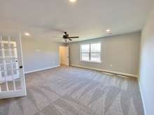 Large bonus room with closet and beautiful glass french doors (photo is of model home with same floor plan)