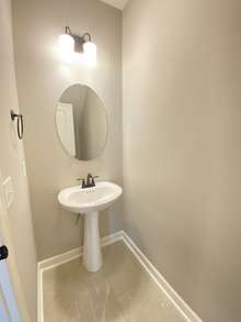 Half bath on main level (photo is from staged model home with same layout)