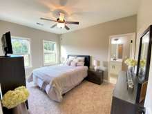 Master Bedroom on main level with attached full bath and walk-in closet (photo is from staged model home with same layout)