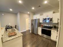 Stainless steel appliances, garbage disposal, custom cabinets, granite counter tops (photo is from staged model home with same layout)