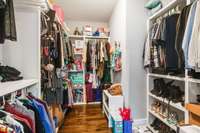 8x10 walk-in primary bedroom closet with custom shelving