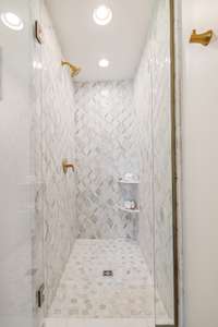 A view of the tiled shower in the main level bathroom.