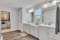 Primary bath with 2 large closets, double vanity with lots of storage and quartz countertops