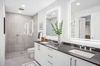 Cool Finish Package bathroom featuring facelit mirrors and a curbless walk-in shower.