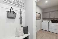 Oversized laundry room & valet area off of garage entry.