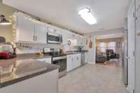 The kitchen features stainless appliances, tile floors, and stainless appliances.