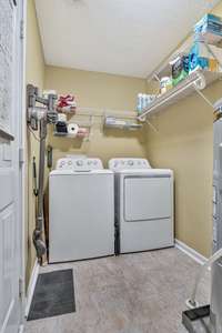 The laundry room is just off of the kitchen.  Washer and Dryer STAY!