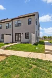 Back of the Unit ~ 10' x 5' concrete patio with sidewalk and grass area plus a privacy fence on both sides.  From here you have access to 2 unassigned parking spaces.