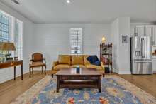 The Living Room has LVP flooring, picture window on the front and a single window on the side wall with 2" faux wood blinds.  There is a recessed light and notice the white shiplap walls.