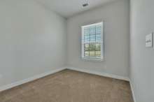 Bedroom 2 ~ neutral carpet and paint, single window with faux wood blinds, closet and wired for ceiling fan with light.