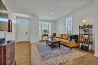 Entry Foyer has recessed light, craftsman panelled door with transom window and black hardware,  coat closet and Powder Room.