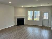 The gas fireplace next the the double windows so you can warm yourself by the fire and take in all the beauty of the backyard view of the White House Greenway and walking trail