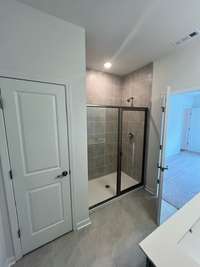 The Primary bath gives you any easy access step in shower and linen closet for plenty of extra storage
