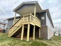 This wooden deck and cover give you years of backyard living and a private view of the White House Greenway