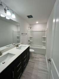 The Secondary Bathroom with double vanity and quartz counters