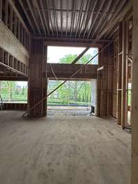 Great Room with 18' coffered ceiling, wood burning fireplace and custom built-ins this home is under construction Built by Ford Classic Homes Photo taken 4/19/2