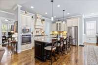 This lovely kitchen features custom cabinets, granite countertops, a huge dining area and a walk-in pantry.