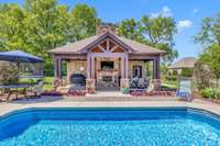 This structure which borders the pool area features a covered TV area and grilling area (with gas line), and is also a detached garage - great for storing the pool and lawn equipment. This garage space is heated and cooled.