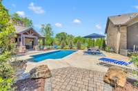 This spot is made for summer fun! Sport depth pool surrounded by a large pool deck and bordered by a covered TV area.