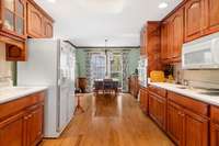 ANOTHER VIEW OF KITCHEN WHICH INCLUDES ALL APPLIANCES, BEAUTIFUL CHERRY CABINETS