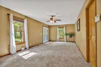 Den with new carpet. The door to the right goes to the laundry room and garage.