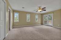 upstairs primary bedroom..the french doors lead to an upstairs porch.