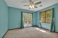 upstairs bedroom with french doors leading to the upstairs porch