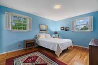 Primary bedroom with beautiful hardwood floors