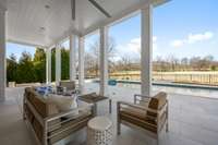 Lower Porch with 24" x 24" Pavers.  12' Soaring Ceilings. Perma-cast Columns.