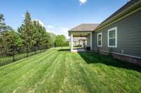 The backyard area is also tree lined.