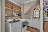 Main level utility room with sink and abundant storage