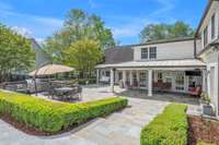 View of covered porch from pool area; perfect for the hot summer days