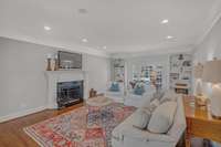 Light-filled living room with wood burning fireplace.