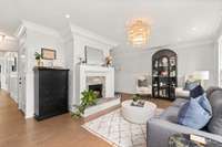 The original part of this 1940's cottage greets you upon entry to the home. It's a great downstairs living room space with a pretty fireplace.